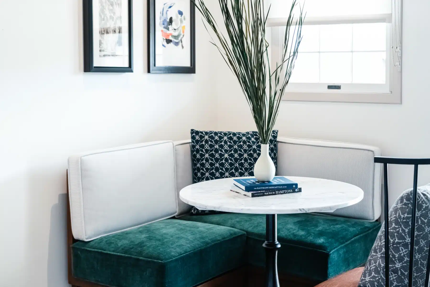 Modern luxury hotel breakfast nook with velvet bench seating and marble table at The Sagaponack in the Hamptons